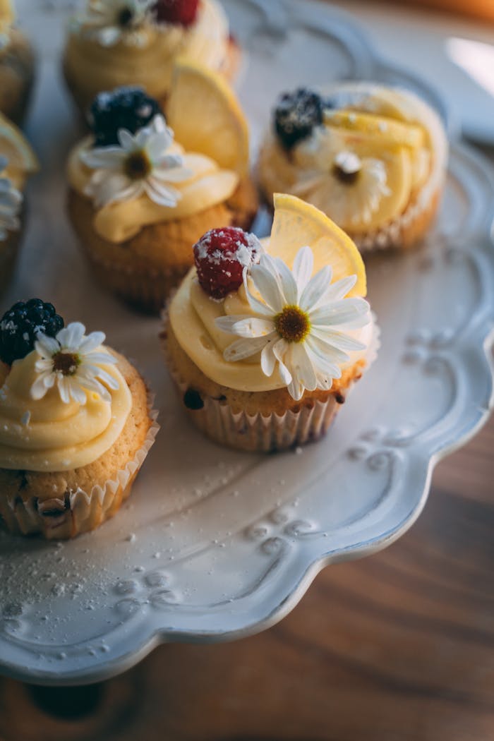 who-we-are Savor the delight of beautifully decorated cupcakes with berries and flowers.